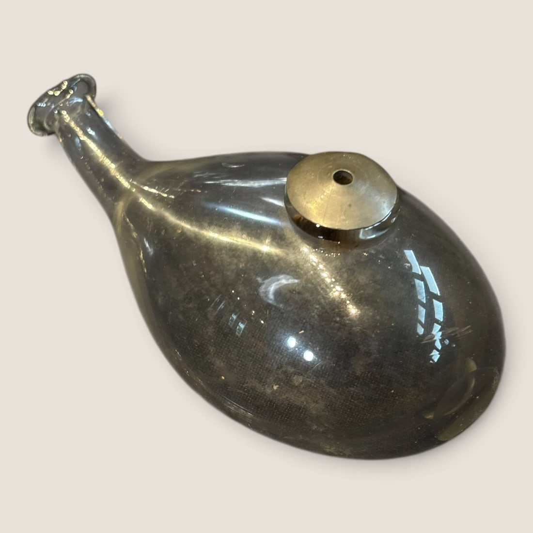 Unusual Antique Glass Nursing Bottle: Unusual antique glass nursing bottle with pewter capped drain hole on front excellent Bid directly at Bid.Ziebarths.com for a lower buyers premium (18%). We offer in-house shipping on all items.