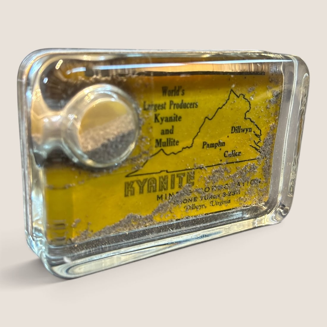 Antique Advertising Glass Paperweight Kyrmite Mining Corporation Dillwyn Virginia: Good clean antique advertising glass paperweight Kyanite Mining Corporation unusual with mining sample inside 4 1/4 x 2 3/4 excellent Bid directly at Bid.Ziebarths.com for a lower buyers premium (18%)