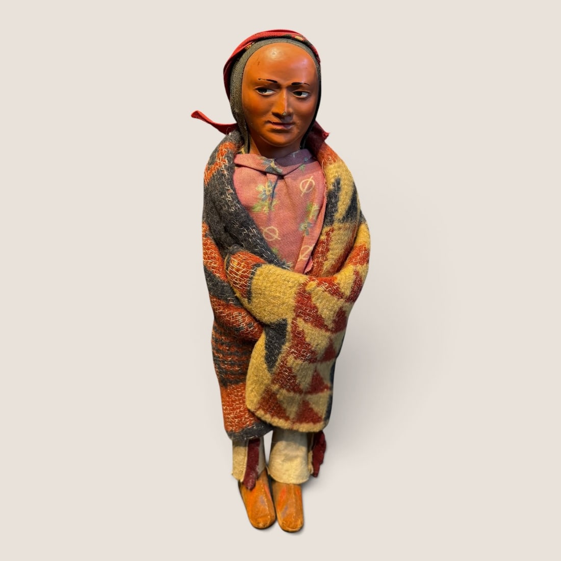 Skookum Bully Good Native American Indian Character Doll: A vintage Skookum Bully Good Native American character doll representing a woman. The figure is constructed with a stuffed textile body and a molded composition face featuring the brand's signature si