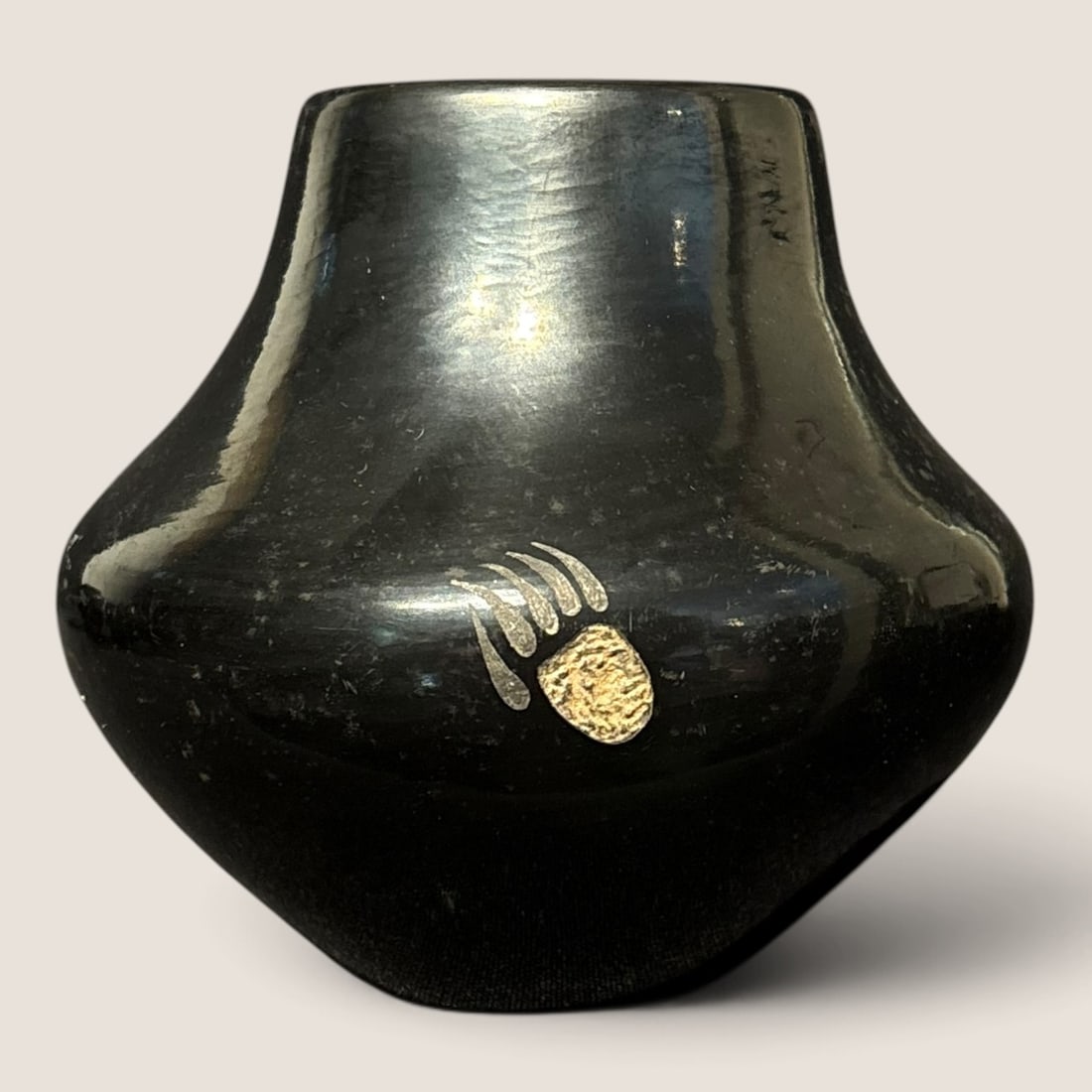 Rare Sgraffito San Ildefonso Vase (Kathy "Wan Povi" Sanchez, 1950 - ): Measuring approx 4 1/4 inches tall, and in excellent condition, the black on black jar features a rare sgraffito design of a bear claw. A fine a rare example. Second half, 20th century.We offer