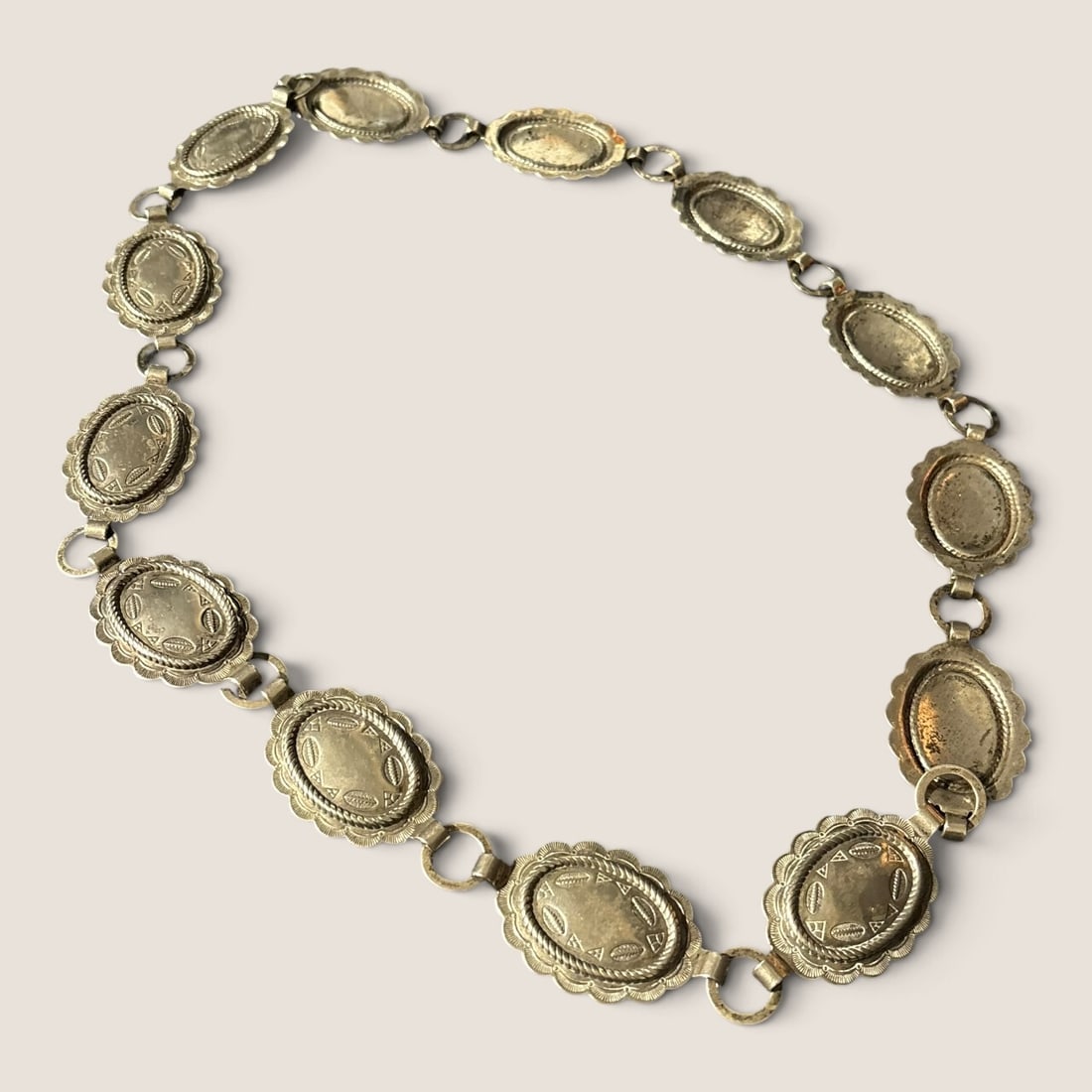 Stamped Metal Concho Belt: Measuring approx 32 inches in length.We offer effecient & affordable in-house shipping on all items in this auction. Bid directly at Bid.Ziebarths.com for our lowest buyers premium (18%)!