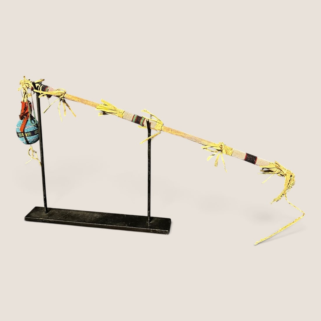 19th C Plains Beaded Skull Cracker Club: Measures approx 30 inches overall with beaded handle, and beaded stone at end. Sinew sewn. circa 1890. Likely Sioux, or Northern Plains.We offer effecient & affordable in-house shipping on all items