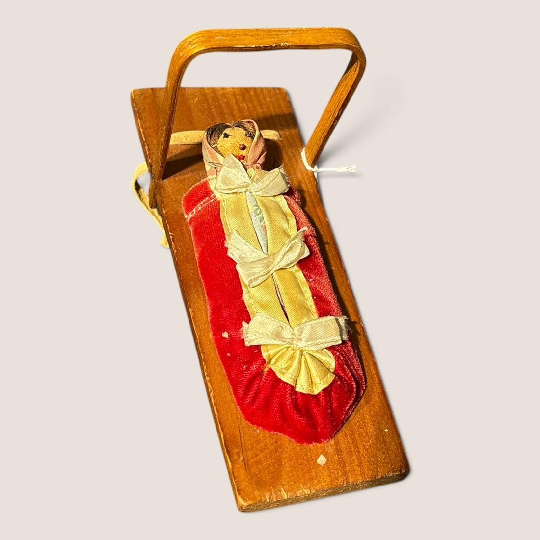Small Toy Doll/Cradle (Papoose): A miniature/toy doll cradleboard. Sticker on back reads GRAND PORTAGE RESERVATION/CHIPPEWA PAPOOSE. Measures 7.5 inches.We offer effecient & affordable in-house shipping on all items in this auction.