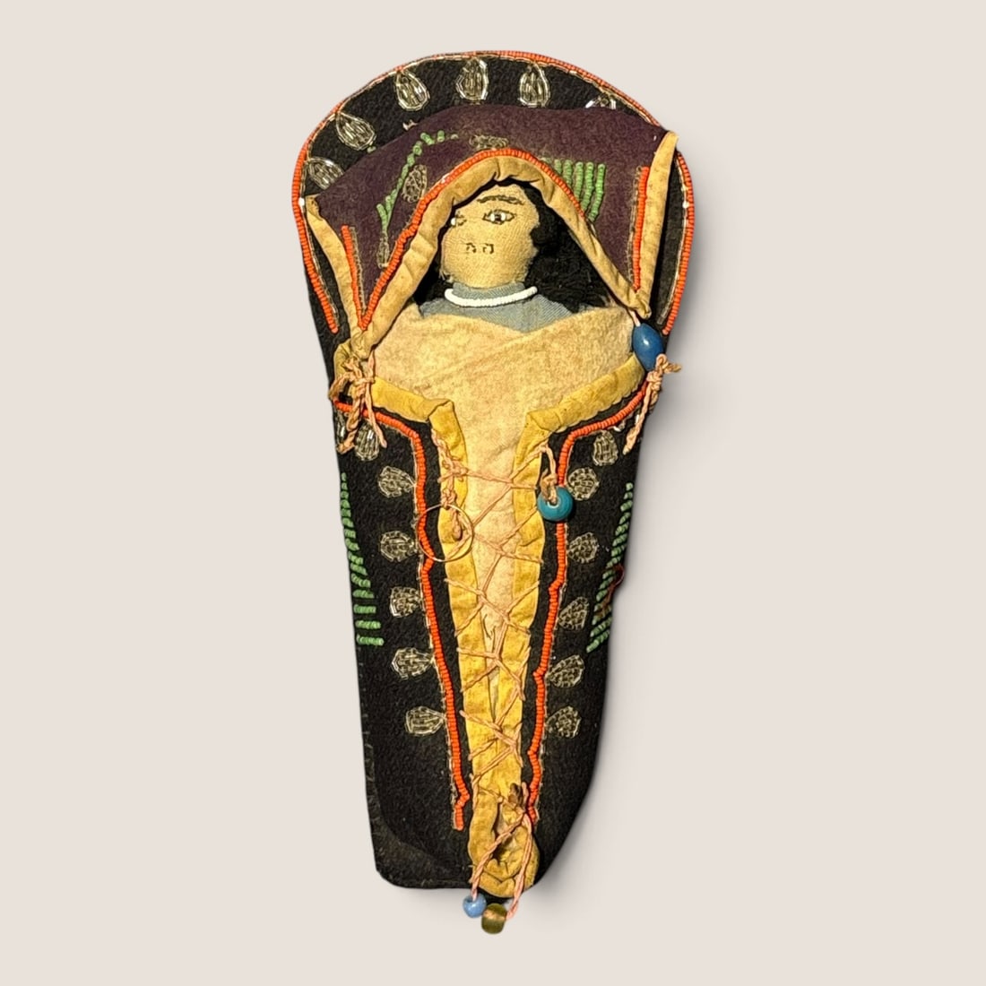Exceptional Northern Plains Doll Cradleboard: The cradle wrapped in a blue trade cloth with a doll in the baby position, beaded throughout, a fine example. Measuring approx 11 inches in length.We offer effecient & affordable in-house shipping on