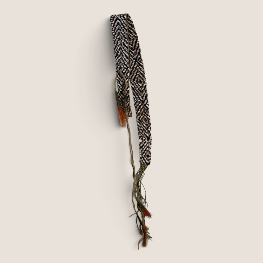 Unique 19th C Plains Beaded Awl Case: Measuring approx 10 x 1 inch, 19th century, good condition with pine cone ornaments.We offer effecient & affordable in-house shipping on all items in this auction. Bid directly at Bid.Ziebarths.com