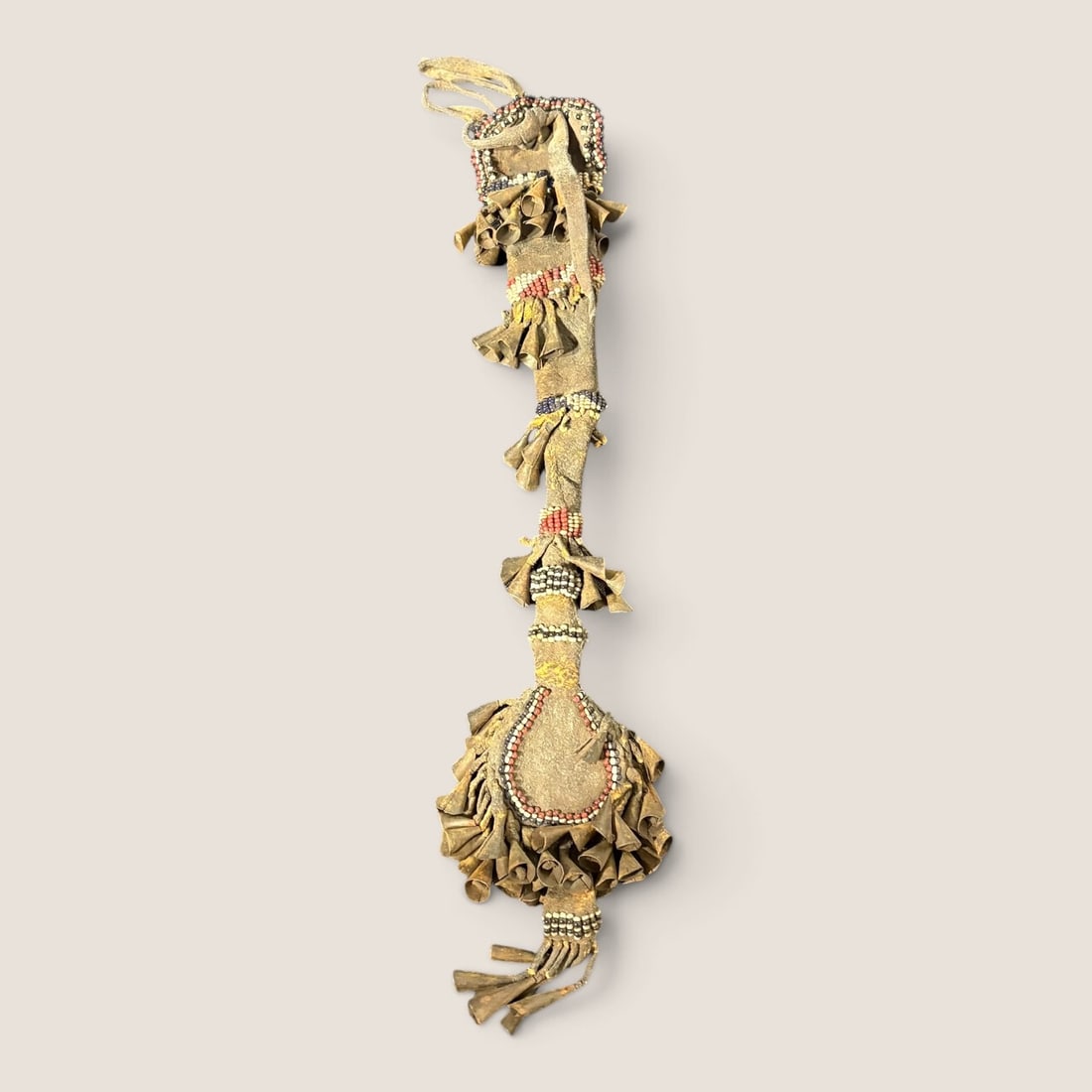 Rare Circa 1850s Apache Awl Case: One of the earliest awl cases we have come across, measuring 12 inches overall with metal cones and pony beadwork of blue, white and red beads. Some bead and cone loss. This is an incredibly early