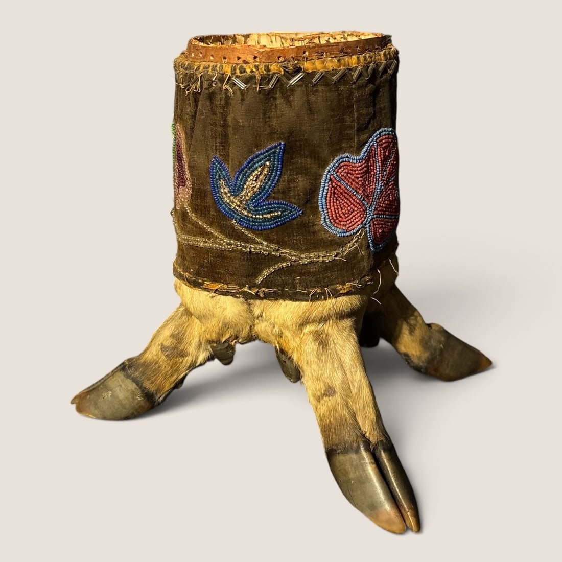 Unique Great Lakes Birch Bark Table Top Canister: A very unique piece of Great Lakes material culture. The piece constructed of birch bark with four deer feet/hooves, with a velvet piece and floral beadwork around it. May have one time been a pin