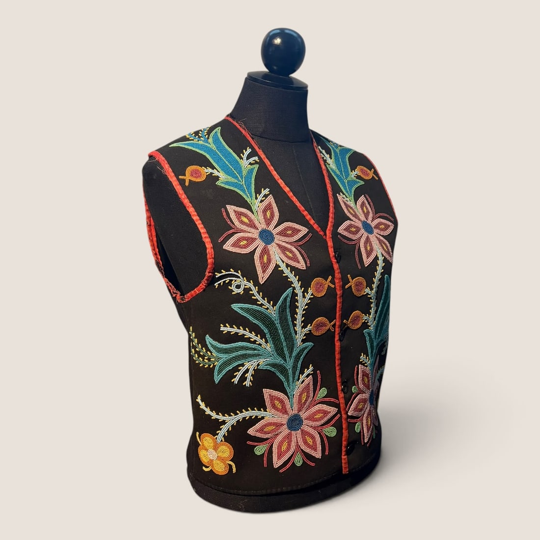 Antique Ojibwe (Chippewa) Native American Floral Beaded Vest: A visually striking Native American beaded vest attributed to an Ojibwe (Anishinaabe) artist of the Great Lakes region, dating to the late 19th or early 20th century. Fashioned from black wool cloth, 