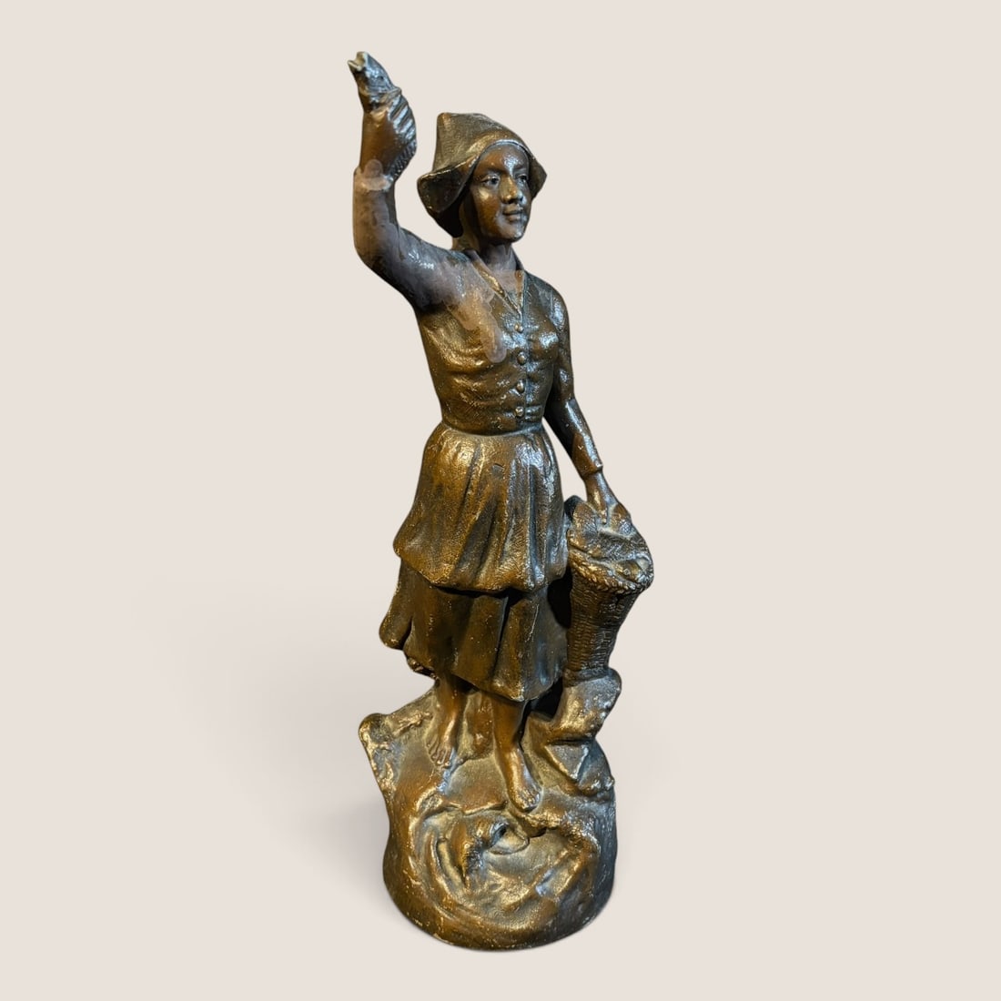 Antique Spelter Figurine, 11 1/2 Inch: An 11 1/2 inch spelter figurine of woman with raised arm on rocks, excellent original bronze finishWe offer effecient & affordable in-house shipping on all items in this auction. Bid directly at Bid.Z
