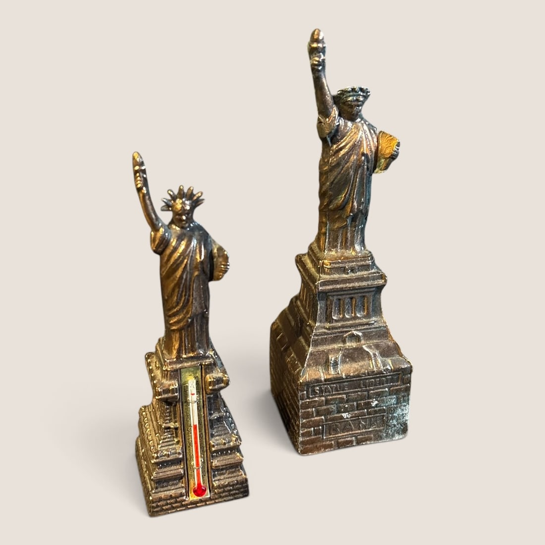 2 Vintage Metal Statue Of Liberty Pieces: 2 vintage metal statue of liberty pieces, 7 & 5 3/4 tall, small one has thermometer, both goodWe offer effecient & affordable in-house shipping on all items in this auction. Bid directly at