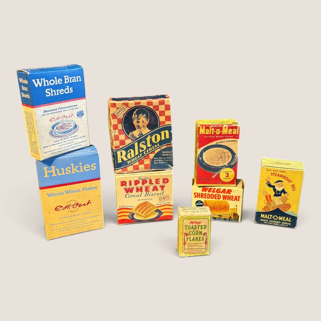 Vtg Kellogg's, Post & Ralston Miniature & Sample Cereal Boxes: This lot features an assortment of eight vintage miniature and sample cereal boxes dating from the mid-1930s to the 1940s. The collection represents early 20th-century American food marketing, featuri