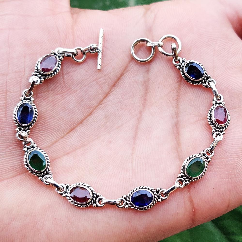 PRECIOUS MULTI GEMSTONE 92.5 STERLING SILVER BRACELET: ITEM : BRACELET MAIN STONE : EMERALD/RUBY/BLUE SAPPHIRE MAIN STONE SHAPE : OVAL MAIN STONE SIZE : 7X5 MM MAIN STONE COLOR : MULTICOLOR METAL : STERLING SILVER METAL PURITY : 92.5 BRACELET SIZE : 7.5" 