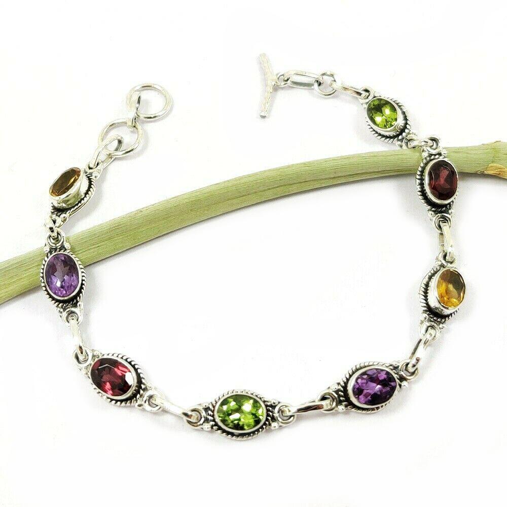 MULTI STONE 92.5 STERLING SILVER BRACELET: MULTI STONE 92.5 STERLING SILVER BRACELET Product Type : BRACELET Main Stone : PERIDOT/GARNET/AMETHYST/CITRINE Main Stone Shape : OVAL Main Stone Size : 7X5 MM Main Stone Color : MULTICOLOR Metal : ST