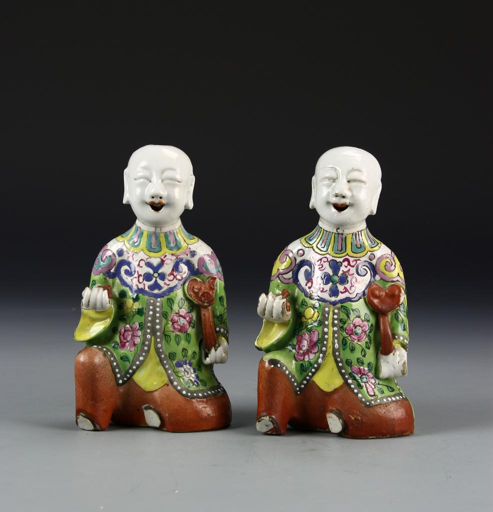 Pair of Chinese Famille Rose Boys: China, 18/19 th C., a pair of Famille Rose boys, identicle in colorful robes and holding a ruyi mushroom top scepter, minor repair on one hand. Height 7 1/4 in.