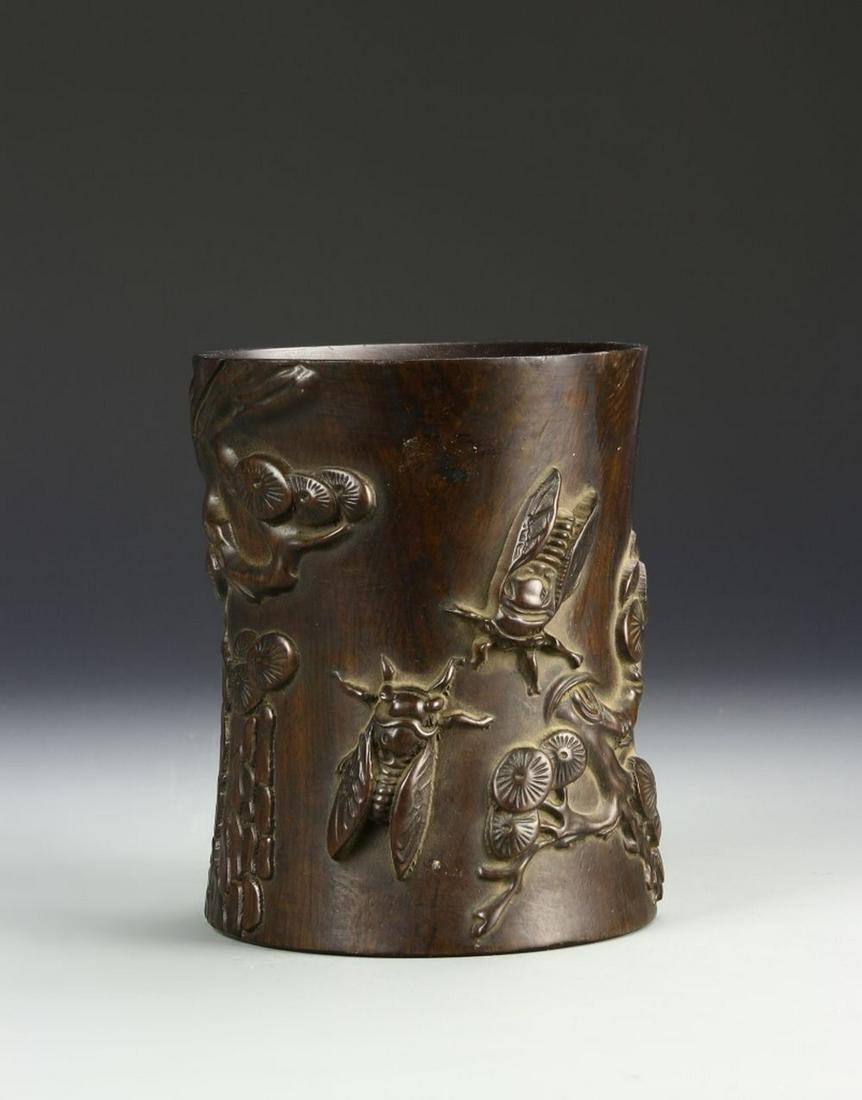 Chinese Hardwood Brush Pot: China, ROC, hardwood brush pot, thick rim at mouth, slightly curved sides to flat base, dark wood throughout with raised carvings of insects and bunches of Ruyi mushrooms. Height 5 7/8 in.