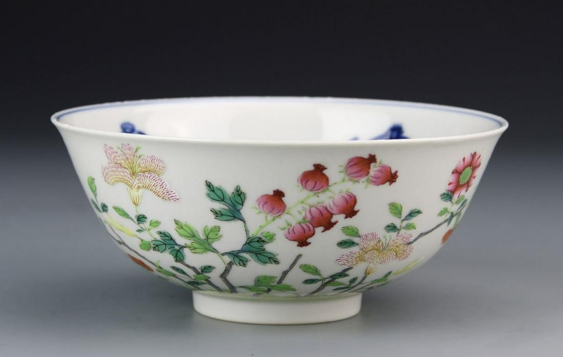 Chinese Famille Rose Bowl: China, 19th C., Famille Rose and blue and white porcelain bowl, poppy pod and floral decorations on the exterior in a multitude of colors, blue and white floral motifs and auspicious symbols on the in