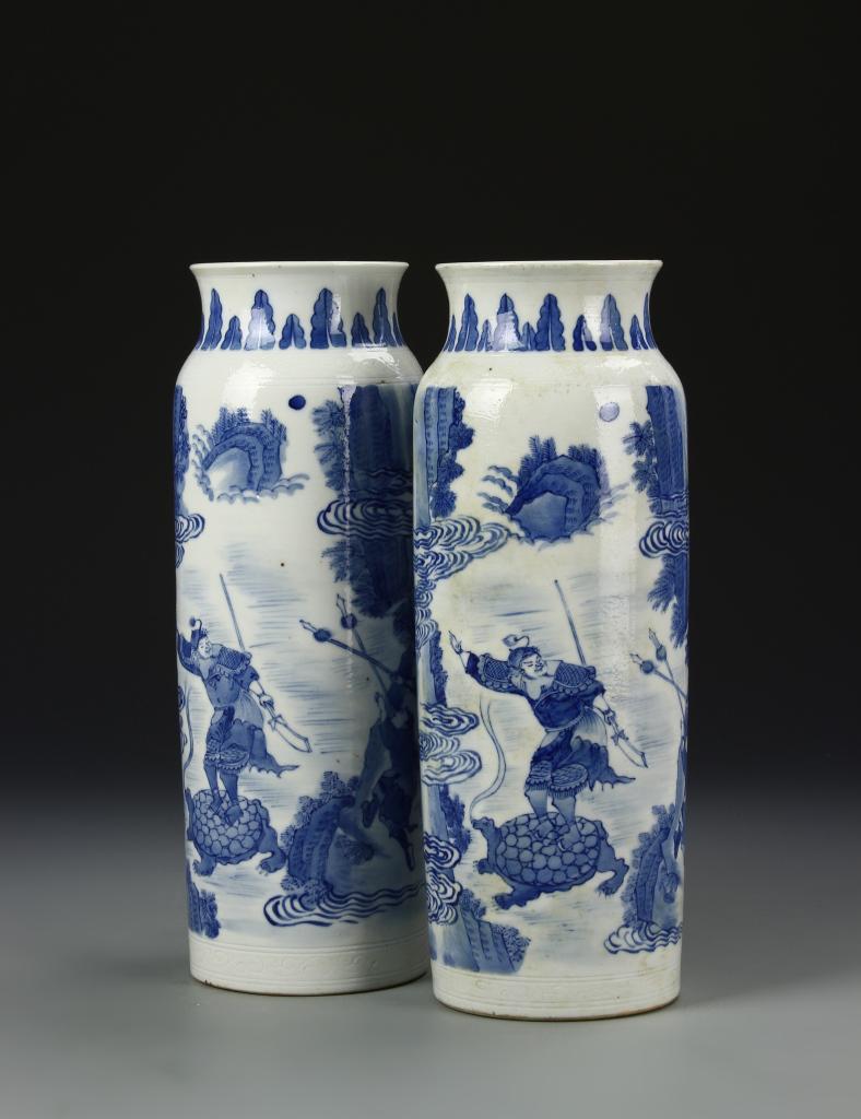 Pair of Chinese Blue And White Vases: China, 19th C., pair of blue and white vases, upward turning rims at mouth, cylindrical body on flat base, matching blue decoration of warriors riding large turtles. Height 10 3/8 in.