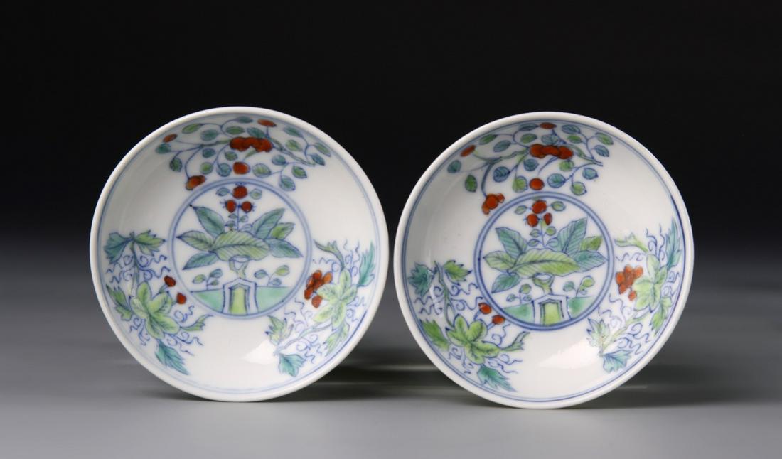 Pair of Chinese Antique Doucai Plates: China, pair of antique Doucai plates, decorated in pale colored leaves with red berries, provenance: Christie's, Lot 25, Dec. 4, 13., Chenghua mark in a double circle on footed base. Length 2 7/8 in.,