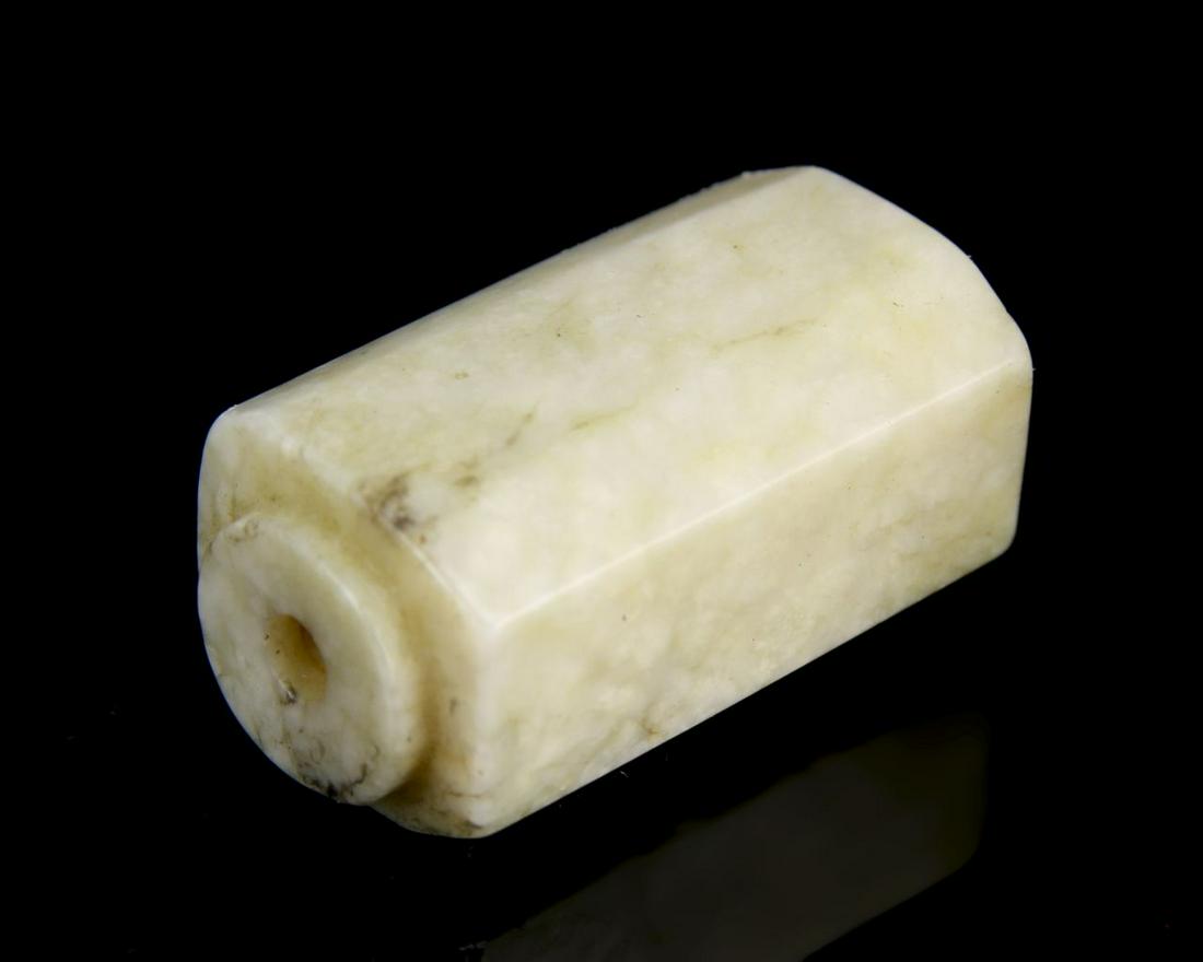 Chinese Jade Cong Pendent: China, jade cong pendent, tubular oblong shape with straight edges and rounded rim with a pierced hole throughout the center. Height 1 3/8 in.