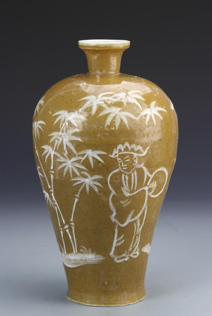 Chinese Brown-Glazed Meiping Vase: China, Ming Period, brown-glazed Meiping vase, decorated in white with large leaves and two figures, with stand, long hairline. Height 11 in.