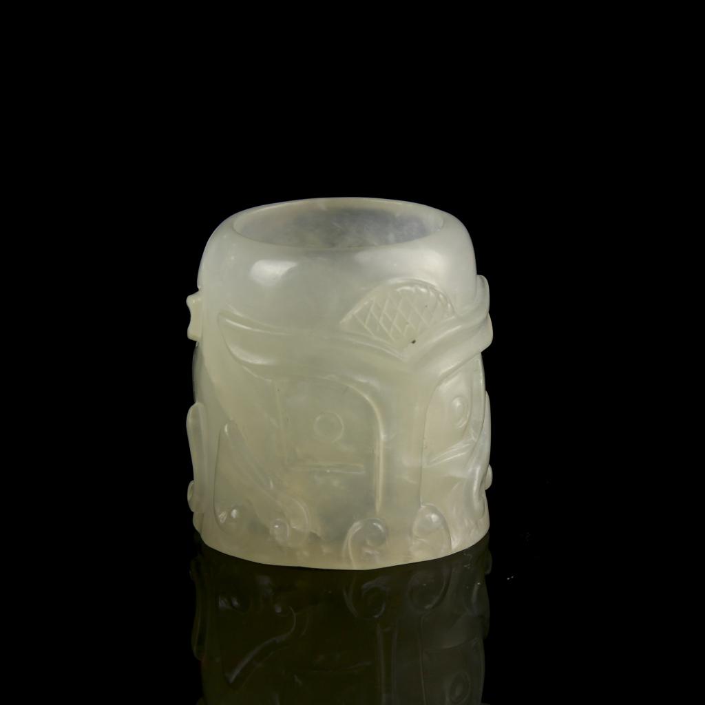 Chinese Jade Carved Thumb Ring: China, jade carved thumb ring, white and almost transparent ring, flat base and delicately carved with symbols. Height 1 1/4 in., Width 1 1/4 in.