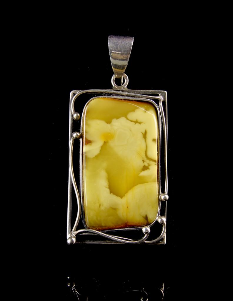 Chinese Silver Pendant: China, Honey Wax and Silver Pendant, rectangular wax piece, with natural swirling patterns visible, in mottled hues of yellow on one side, and orange on the other, the piece framed by scrolling silver