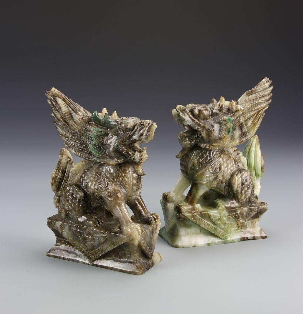 Pair of Chinese Foo Dogs: China, pair of foo dogs, both in seated guarding positions, large flame-like appearance at the back of their heads, mouths open with teeth showing. Height 8 in.