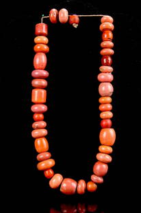 Tibetan Coral Beaded Necklace: Tibet, coral beaded necklace, mix of shaped and sized beads, round, oblong and oval, closely strung together in various complimentary coral hues. Length 22 in.