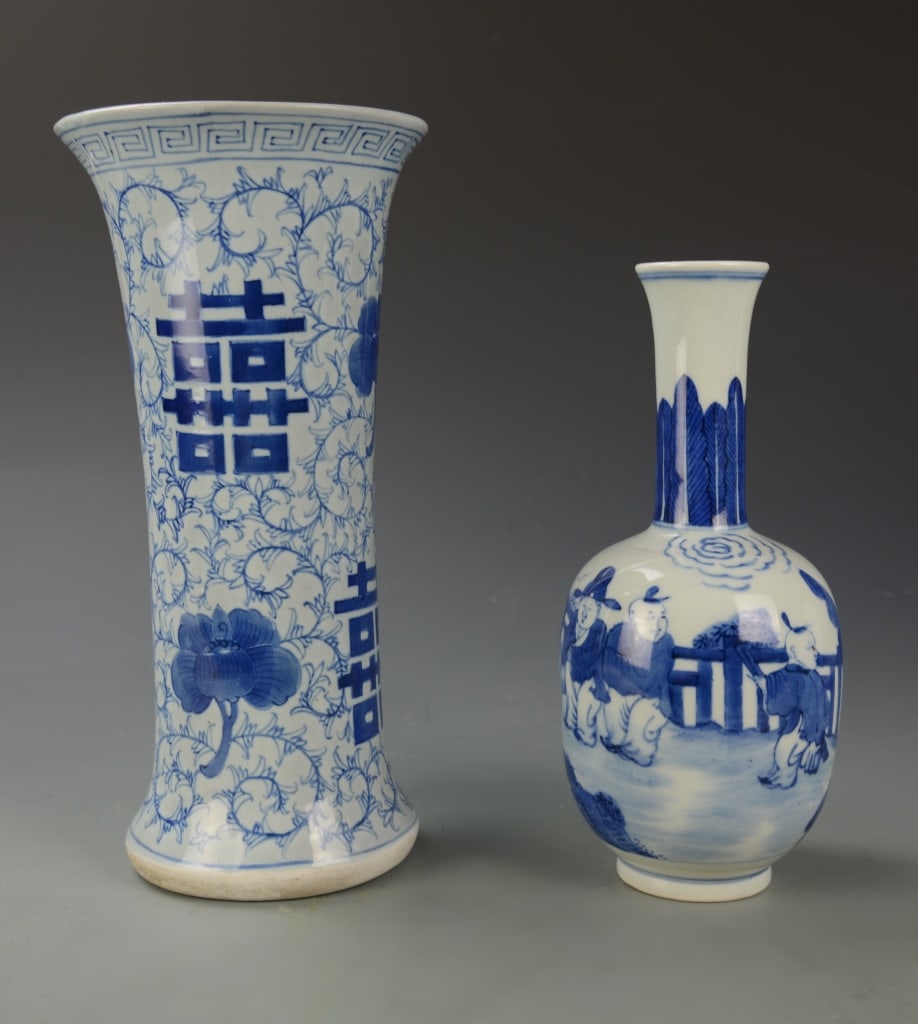 Two Chinese Blue and White Vases: China, 19th C. Two blue and white vases with mark on base. One is tall with a flared rim, depicting stylized vines and large calligraphy, with a key fret band just under the rim. The other vase is bul