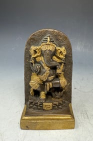 A brass idol of Lord Ganesha, a prominent deity in Hinduism.