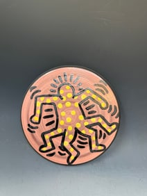 A plate of art signed Keith Haring Signed on Back