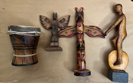 Four wood carvings measure in the highest one is 13 inches tall