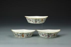 Three Antique Chinese Famille Rose Bowls: China, 19th C., a set of three export Famille Rose bowls, each on a flat base with scalloped rim, with brightly painted illustration of robed figures over a white ground. Width 8 1/8 in., Depth 4 3/8