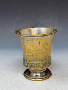 An antique silver-plated cup,likely a christening or birth cup: An antique silver-plated cup, likely a christening or birth cup, with bright-cut engraving of a dog in wild and an aesthetic design. Bottom marked: A Ledig & Son ~ Phila, Approximately 3 inches high.