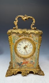 An Antique travel alarm with depictions from the oeuvre of Alfons Mucha