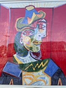A framed print of Pablo Picasso's "Buste de Femme".