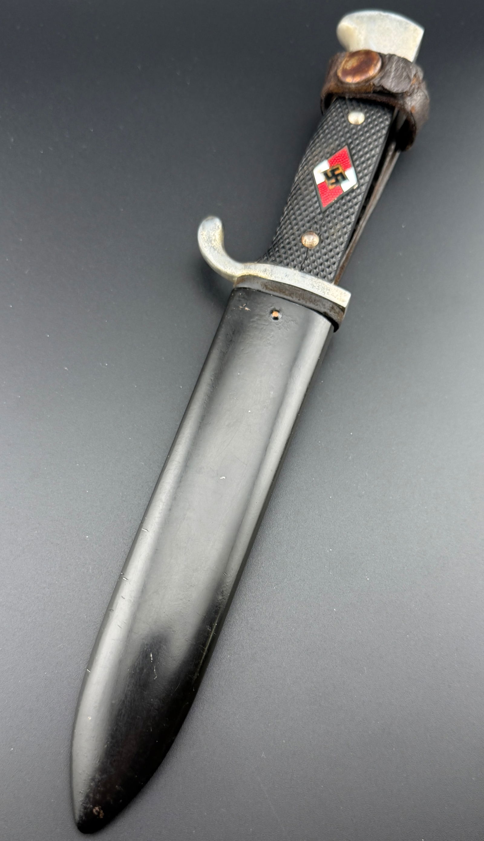 WWII GERMAN HITLER YOUTH KNIFE 1940 RZM M7/42: WWII German Hitler Youth Knife RZM M7/42 1940. Bright, straight blade. Maker mark / logo "RZM M7/42" and dated 1940 on ricasso. Leather buffer pad. Nickel plated hilt with black checkered bakelite gri