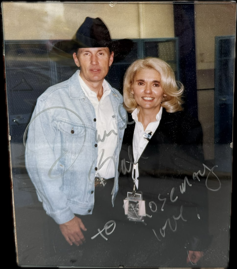 A signed photograph of actor Bruce Boxleitner with a woman: A signed photograph of actor Bruce Boxleitner with a woman. Boxleitner is an American actor and author known for his roles in television series and films. Size: 8” X 10”, framed with glass