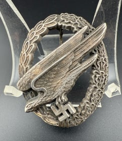 WWII German Luftwaffe Paratrooper Badge By B&NL: WWII piece. Two-piece construction: laurel–oak wreath with a diving Luftwaffe eagle over a swastika. Reverse maker-marked B&NL (Berg & Nolte, Lüdenscheid); original hinge, pin and catch present and