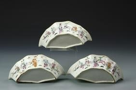 Three Antique Chinese Famille Rose Bowls: China, 19th C., a set of three export Famille Rose bowls, each on a flat base with scalloped rim, with brightly painted illustration of robed figures over a white ground. Width 8 1/8 in., Depth 4 3/8 