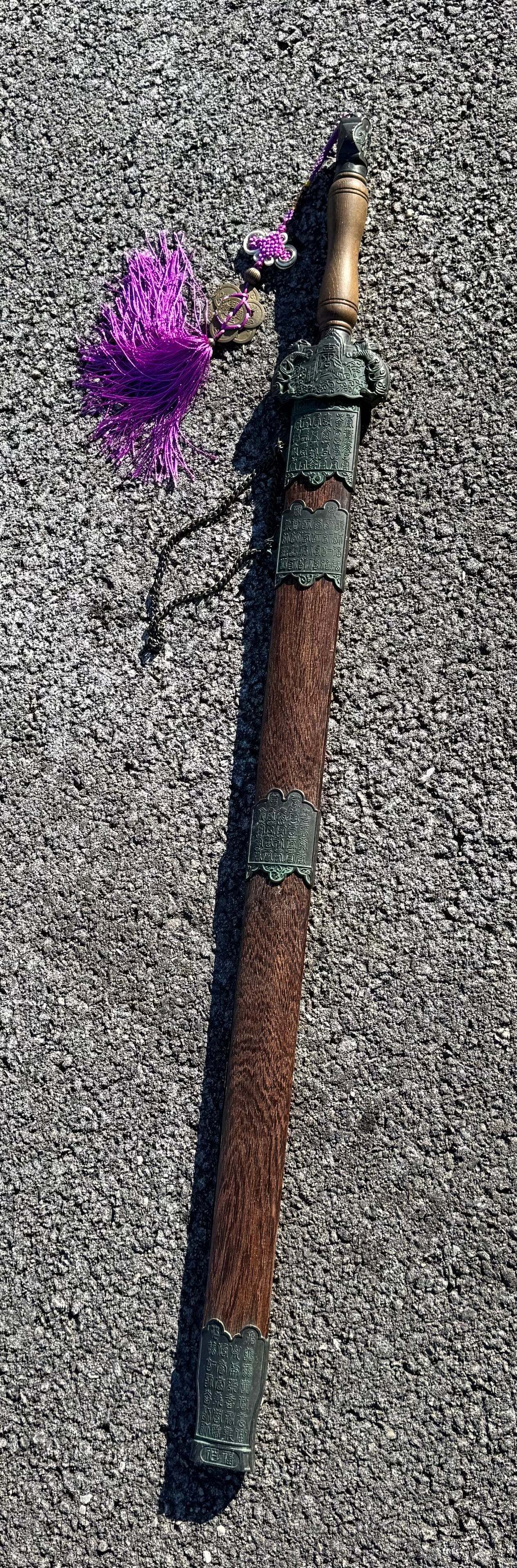 A Chinese straight sword, or Jian, with a wooden scabbard and decorative metal fittings: A Chinese straight sword, or Jian, with a wooden scabbard and decorative metal fittings, 40.5 L