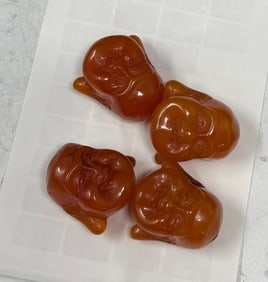 Four Chinese Amber Buddha Heads: Four Chinese Amber Buddha Heads, approximately one and a quarter inch high each