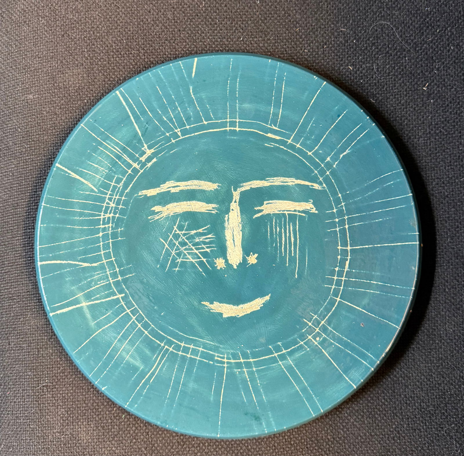 A light blue round pottery hanging round plaque with Picasso print on the back (1 of 4)