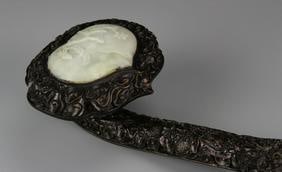 Antique Chinese Jade and Wood Ruyi Scepter: China, 19th C., jade and wood ruyi scepter., the pale white head carved with a flowering branch, the shaft of the scepter densely carved with undulating organic and floral motifs as well as additional