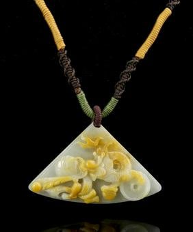 Chinese Yellow Jade Pendant: China, yellow jade pendant, woven cord with triangular white stone, with a symbol on one side and raised carving of mythical creature within flames on the other. Length 4 in., Height 2 1/2 in.