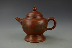 Antique Chinese Yixing Teapot: China, antique Yixing teapot, round body on pedestal base, looped handle and short spot, decorated with a bridge scene between trees, signed by Gujinzhou. Height 5 1/2 in.