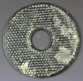 Antique Chinese Jade Pi: China, antique jade pi, intricately carved with a densely patterned geometric design, natural light mottles in the dark stone, studded surface and smooth along edges. Width 7 1/4 in.