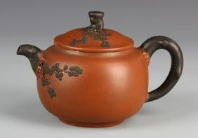 Chinese Yixing Zisha Teapot by Jiang Rong: China, Yixing Zisha teapot by Jiang Rong, round body, large round handle, small spout, with naturalistic floral design, signed by Jiang Rong. Height 5 1/2 in., Width 5 1/2 in.