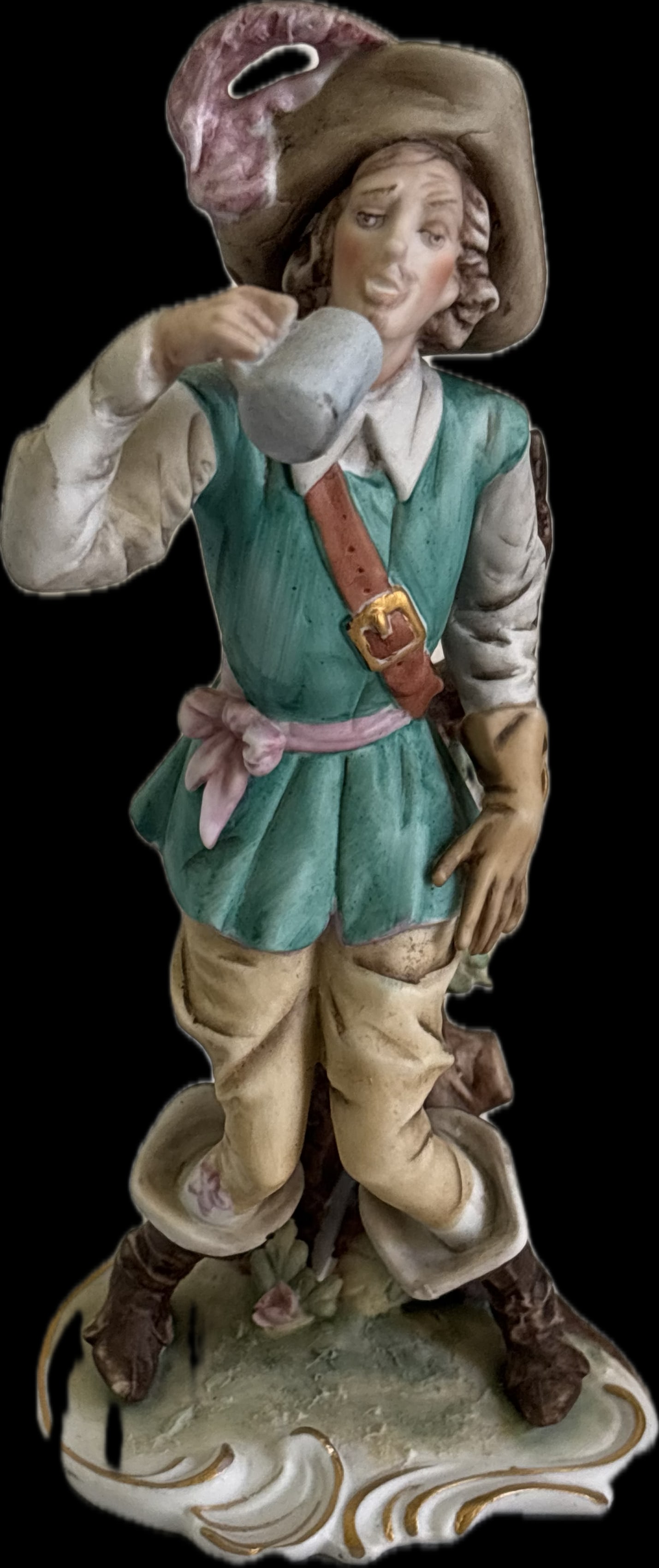 An antique porcelain figurine depicts a drunken musketeer: An antique porcelain figurine depicts a drunken musketeer or tavern man, likely manufactured in Germany, Similar pieces are often part of a pair or set depicting rustic, historical, or comedic charact