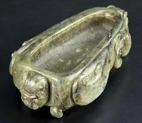 Antique Chinese Carved Jade Water Pot: China, antique carved jade water pot, in an irregular form, with naturalistic decorations of plants and mythical creatures in relief. Height 4 3/4 in., Width 2 3/4 in.